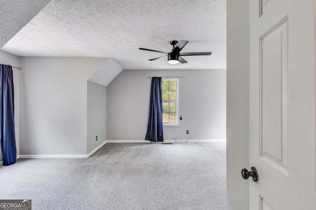 additional living space with carpet flooring, ceiling fan, and a textured ceiling