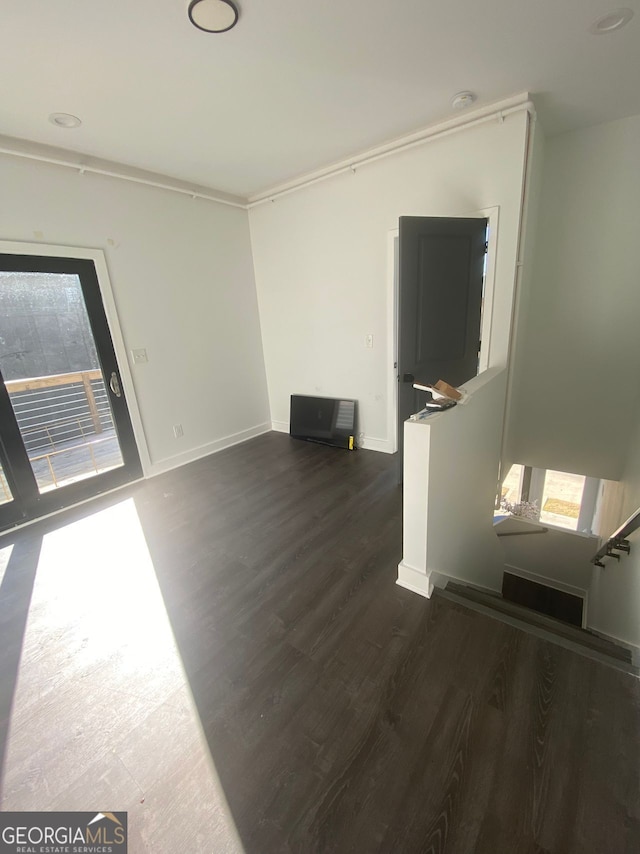 spare room featuring dark wood-type flooring