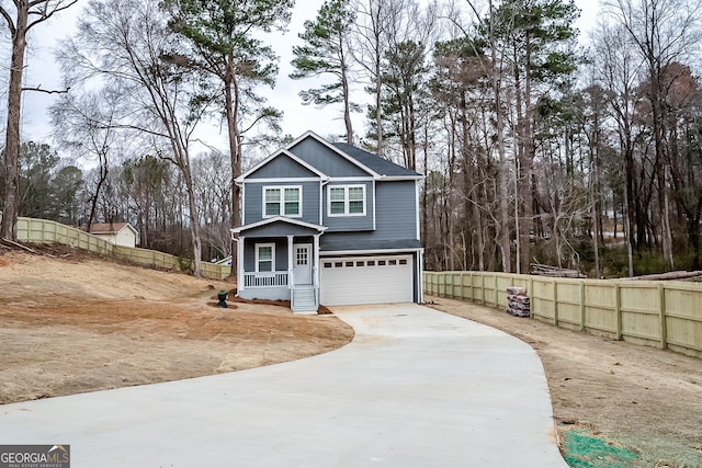 traditional-style home with driveway, board and batten siding, an attached garage, and fence