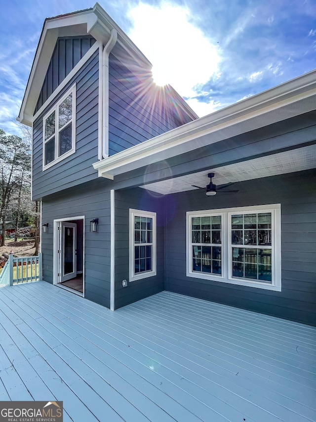 wooden terrace featuring a ceiling fan