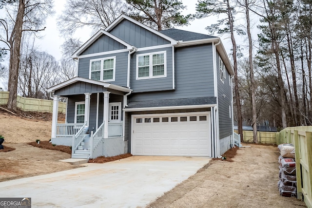 view of front of home with concrete driveway, a porch, a shingled roof, and fence