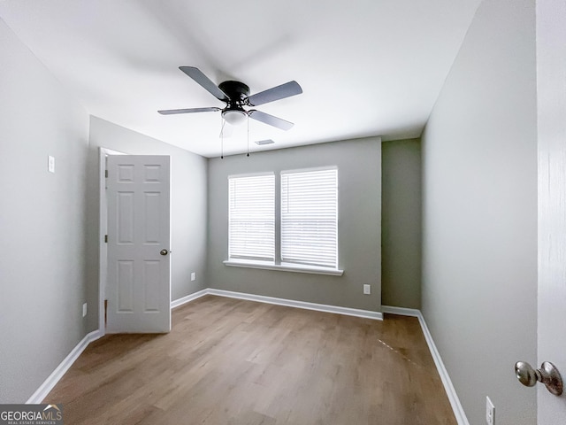 unfurnished bedroom with ceiling fan, wood finished floors, visible vents, and baseboards