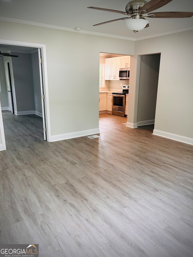 unfurnished living room featuring light hardwood / wood-style flooring, ceiling fan, and crown molding