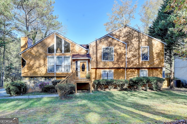 view of front of home with a front yard and central air condition unit