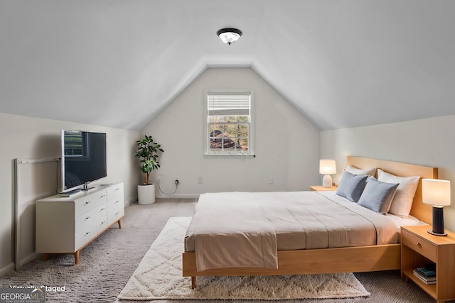 carpeted bedroom with vaulted ceiling