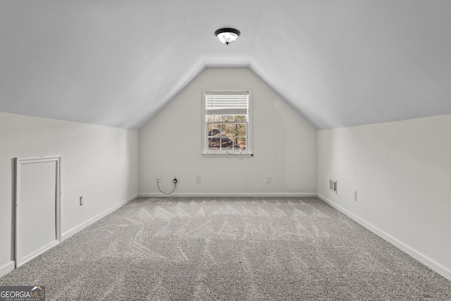 additional living space with light carpet and lofted ceiling