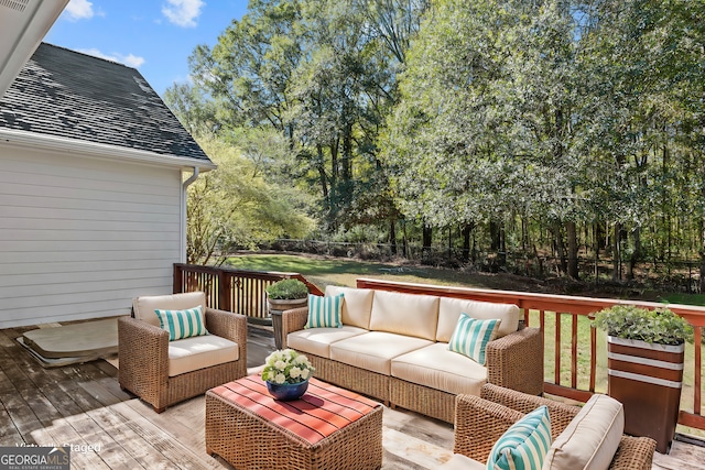 wooden deck featuring a yard and an outdoor hangout area