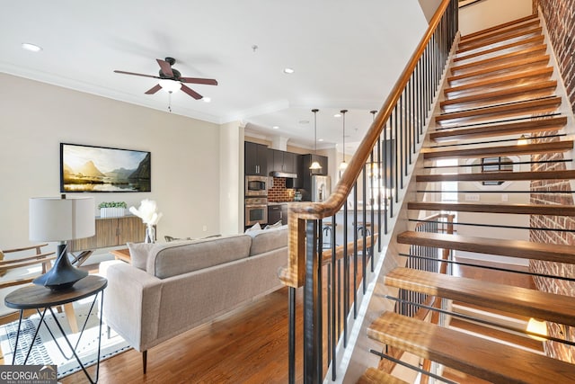 living room featuring ceiling fan, dark hardwood / wood-style floors, and ornamental molding