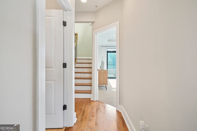 hallway with light hardwood / wood-style flooring