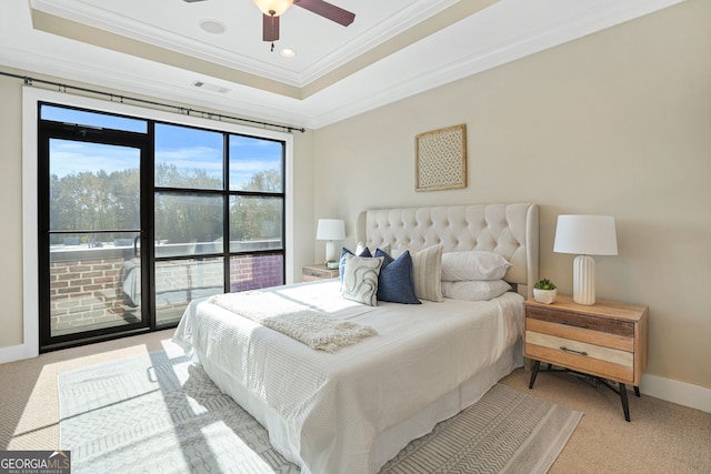 bedroom featuring ornamental molding, access to outside, light colored carpet, ceiling fan, and a tray ceiling