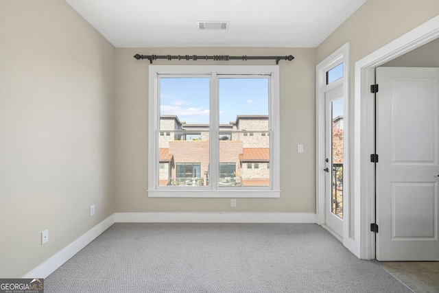 spare room with light carpet and a healthy amount of sunlight