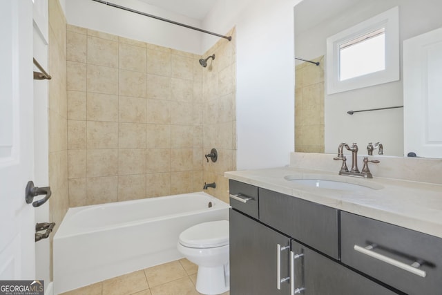 full bathroom featuring tile patterned flooring, vanity, tiled shower / bath combo, and toilet