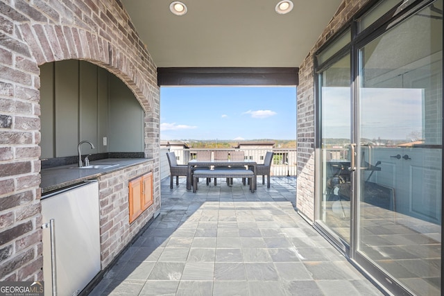 view of patio featuring sink and an outdoor kitchen