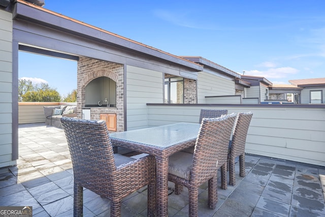 view of patio / terrace featuring sink and an outdoor kitchen