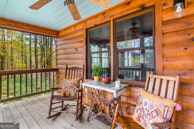 sunroom featuring ceiling fan and plenty of natural light