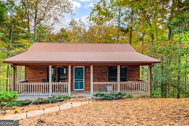 log-style house with a porch