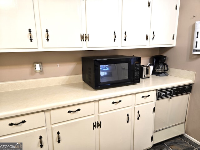 kitchen with white dishwasher and white cabinets