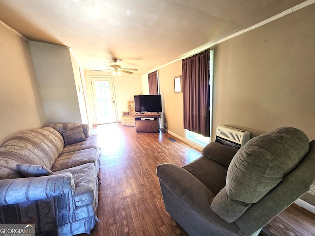 living room featuring hardwood / wood-style floors, ceiling fan, and crown molding