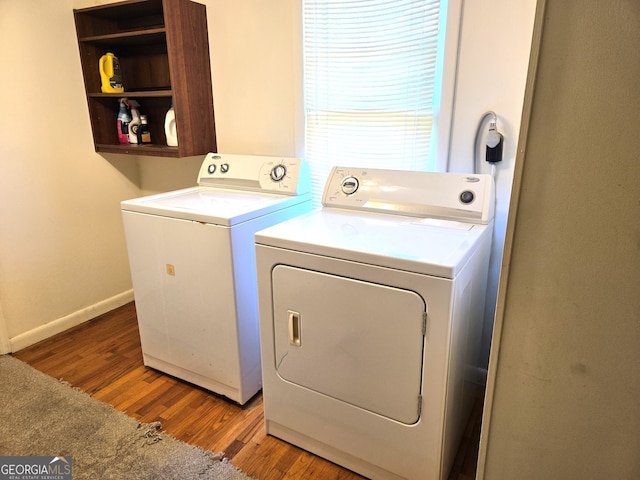 laundry room with hardwood / wood-style floors and separate washer and dryer