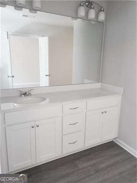 bathroom with vanity and wood-type flooring