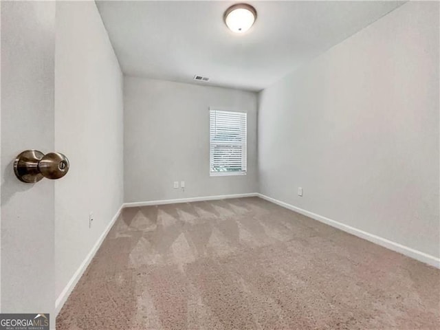 unfurnished room with light colored carpet