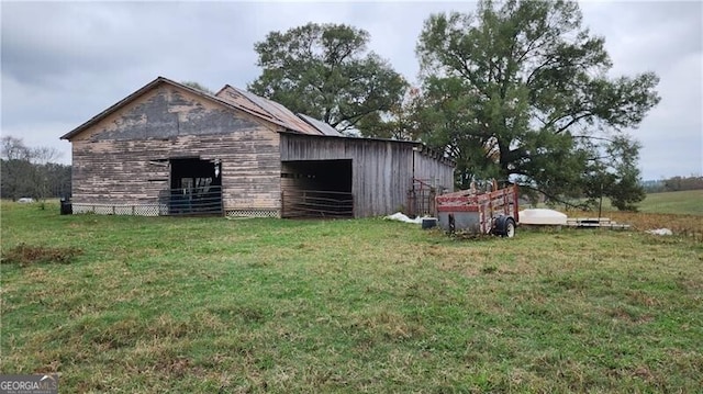 view of outbuilding with a lawn