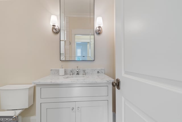 bathroom featuring vanity and toilet