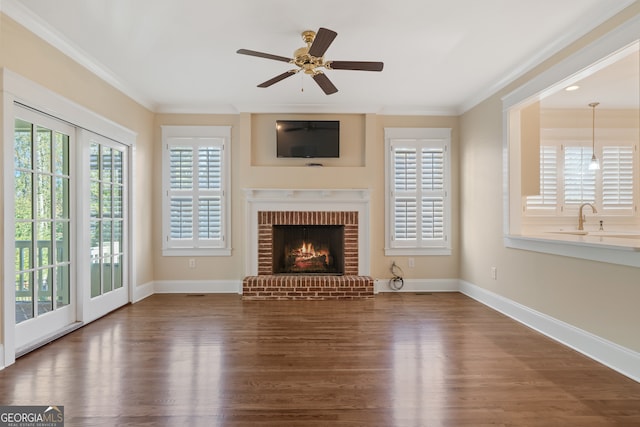 unfurnished living room with dark hardwood / wood-style floors, ceiling fan, crown molding, and sink