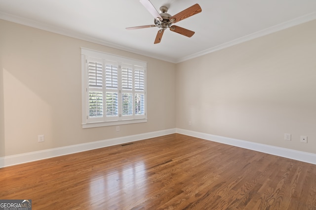 spare room featuring hardwood / wood-style floors, ceiling fan, and crown molding