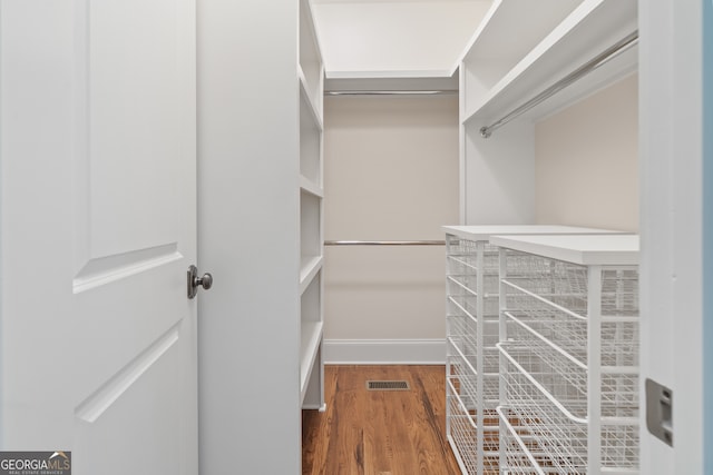 spacious closet featuring dark wood-type flooring