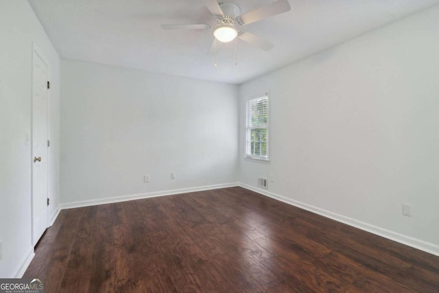 unfurnished room featuring ceiling fan and dark wood-type flooring