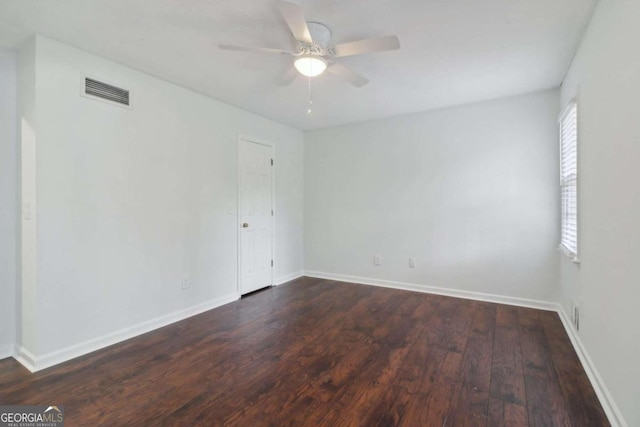 empty room with ceiling fan and dark wood-type flooring