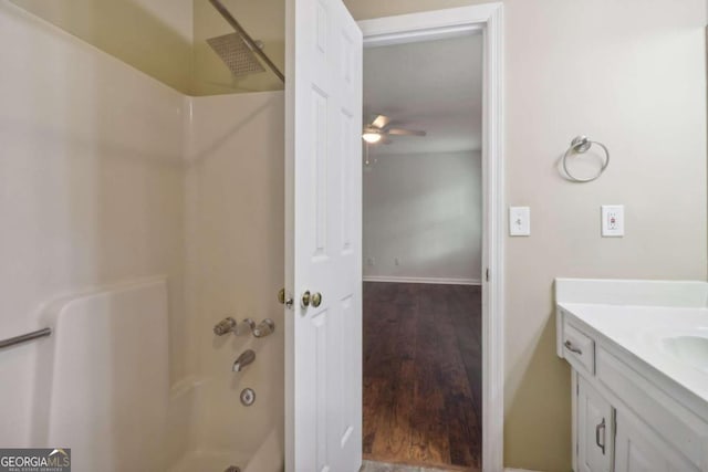 bathroom featuring wood-type flooring, vanity, ceiling fan, and tub / shower combination