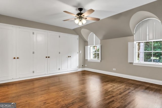 bonus room with dark hardwood / wood-style floors, ceiling fan, and vaulted ceiling