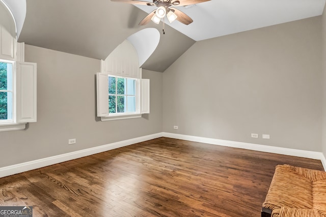 additional living space with ceiling fan, dark hardwood / wood-style flooring, and vaulted ceiling