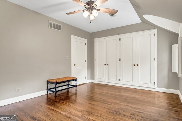 bedroom with dark hardwood / wood-style floors and ceiling fan