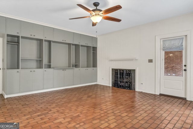 unfurnished living room with ceiling fan