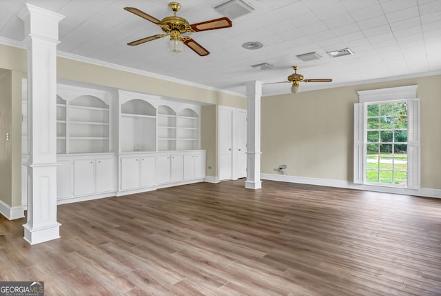 unfurnished room featuring light hardwood / wood-style floors, ornamental molding, and decorative columns