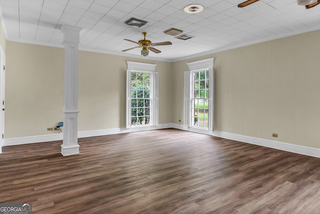 unfurnished room featuring dark hardwood / wood-style flooring, decorative columns, ceiling fan, and crown molding