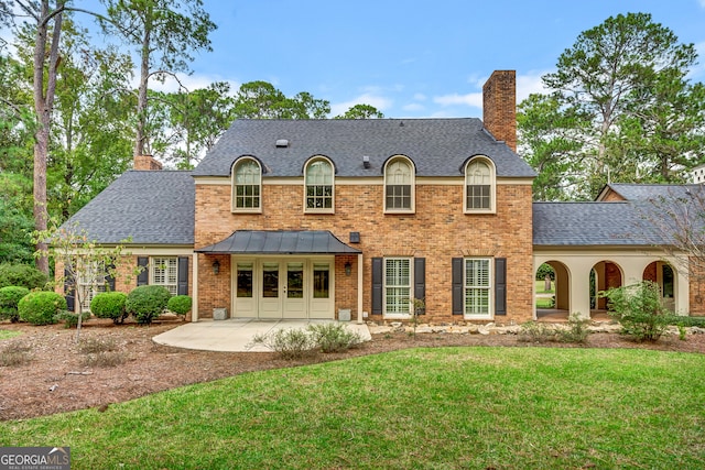 view of front facade with a patio area and a front lawn