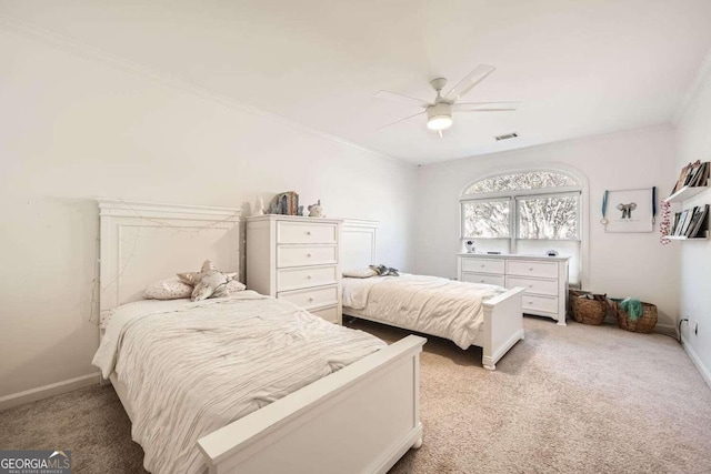 carpeted bedroom with ceiling fan and ornamental molding