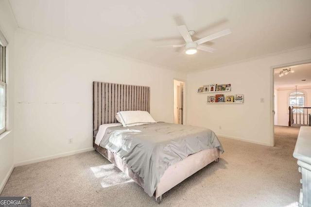 bedroom with ceiling fan, light colored carpet, and ornamental molding