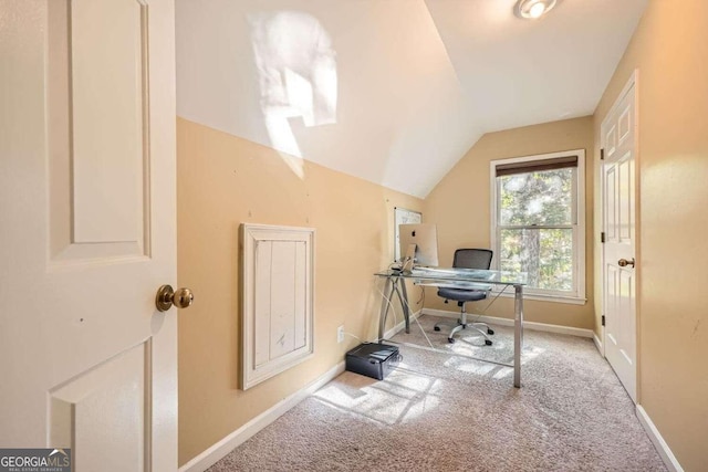 carpeted office with lofted ceiling