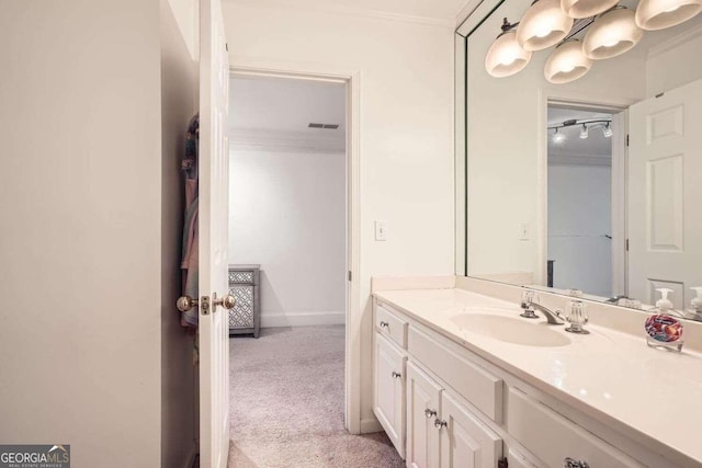 bathroom with vanity and crown molding