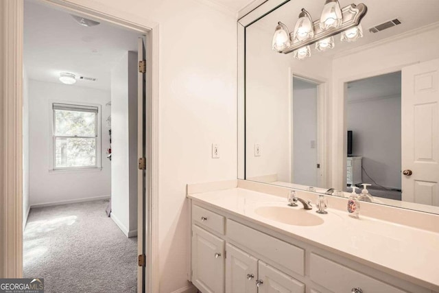 bathroom with crown molding and vanity