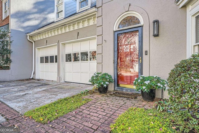 view of exterior entry featuring a garage