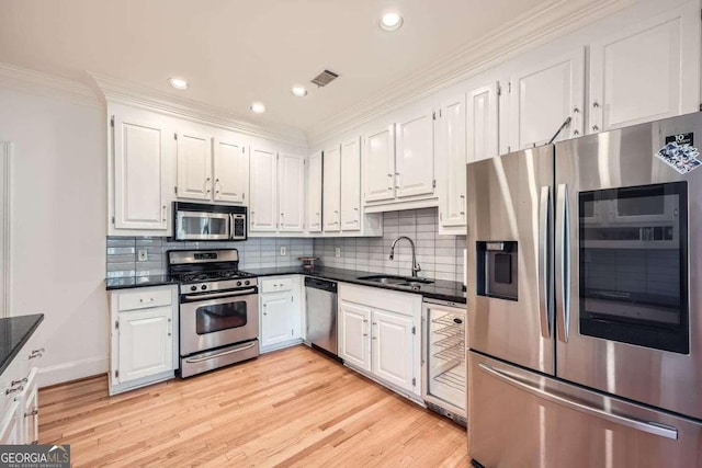 kitchen featuring sink, white cabinetry, and stainless steel appliances