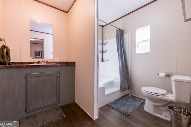 full bathroom featuring ornamental molding, vanity, shower / bathtub combination with curtain, hardwood / wood-style floors, and toilet