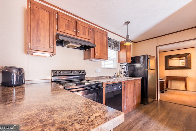 kitchen with pendant lighting, black appliances, ornamental molding, a textured ceiling, and dark hardwood / wood-style flooring