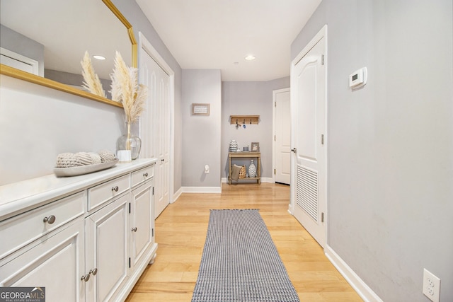 hall with light hardwood / wood-style floors